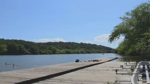 Sunny day river deck couple laying in the sun Stock Footage 63568243