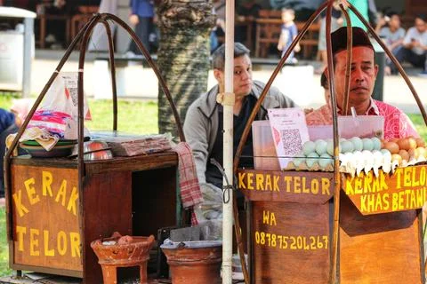 Sunny day scene with two rustic wooden carts selling Kerak Telor, a tradition Stock Photos