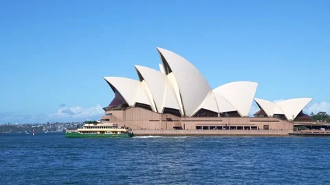 Sunny day view of the Sydney Opera House with a ferry crossing the blue harbour. Stock Footage 345313798