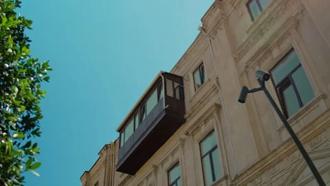 Sunny Day View Upward Between Historic Buildings with Tree and Lamp Post Stock Footage 338243424