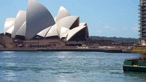 A sunny daytime view of the iconic Sydney Opera House from the water Stock Footage 344085744