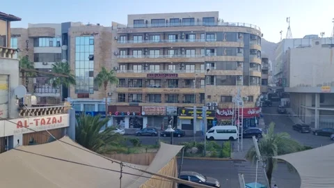 Sunny evening city view in central Aqaba, Jordan, showing light traffic, local Stock Footage 337102744