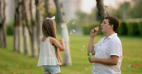 Sunny family blowing air bubbles. slow motion Stock Footage