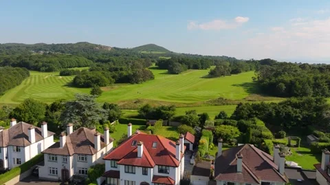 Sunny Golf Course Behind Leafy Suburban Street in Sutton Dublin Stock Footage 338077637