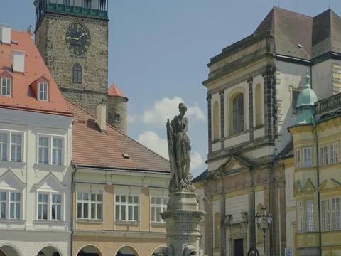 Sunny medieval Renaissance square with stone sculpture, tower and clock. Stock Footage 75934089