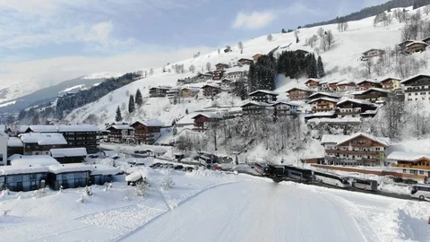 Sunny Mountain Ski Resorts Accommodations on hill   Austria Europe Aerial view Stock Footage 104231285