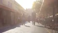 Sunny narrow street with cafes and walking tourist, summer vacation, weekend HD Footage
