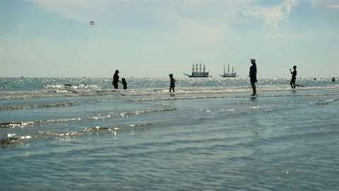 Sunny ocean landscape with tourists vacationers and children. Sailing ships Stock Footage