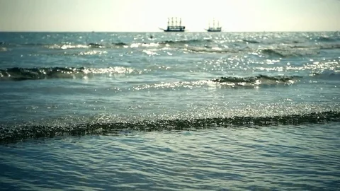 Sunny ocean landscape with waves. Waves os surf. Old sailing ships in sea Video stock 77914937