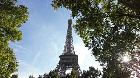 Sunny Paris Trees Framing the Eiffel Tower Against Blue Sky Stock Footage 345515465