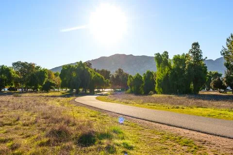 Sunny Paved Pathway Through Trees and Dry Grass, Lake Perris Area Stock-Fotos