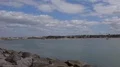 Sunny Praia da Rocha beach and hotel buildings skyline panning Portugal 4k or 4k+ Resolution