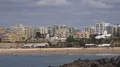 Sunny Praia da Rocha beach and hotel buildings skyline panning Portugal 4k or 4k+ Resolution