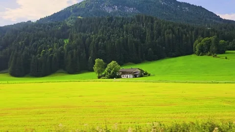Sunny railway view through rolling meadows, small villages, dark pine forests Stock Footage 337923276