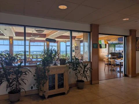 Sunny restaurant interior with large windows Stock Photos