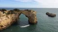 Sunny sand stone cliffs arch rock at Algarve coastline Portugal 4k or 4k+ Resolution