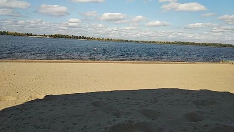 Sunny sandy river beach with calm water and natural shoreline Stock Footage 327789791