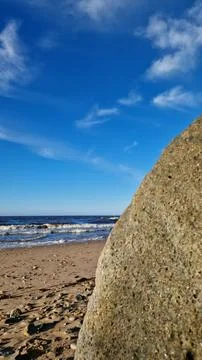 Sunny Seaside with Boulder and Blue Sky Foto stock