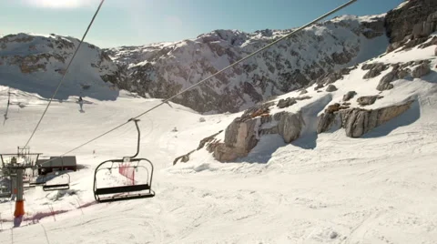 Sunny Shot Of Snow Covered Ski Slope Without Skiers And Empty Operating Ski Lift Stock Footage 45915249