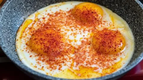 Sunny side up egg in the pan. Cooking eggs on the stove for breakfast. Stock Photos
