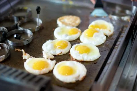 Sunny side up eggs on grill Stock Photos