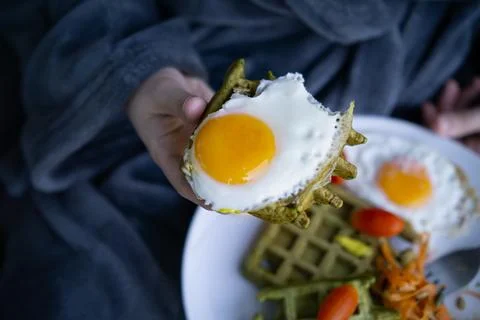 Sunny side up fried egg served with fresh vegetables. Stock Photos