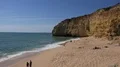 Sunny silent hidden beach between cliffs with cute dog at Algarve 4k or 4k+ Resolution