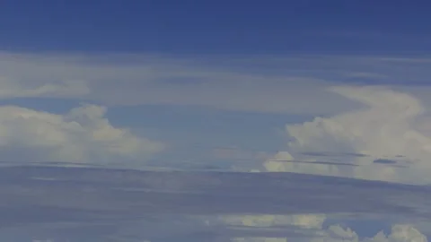 Sunny Sky and Clouds Through Airplane Window Stock Footage 337376839