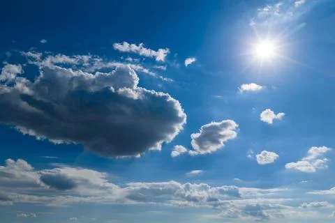 Sunny sky background with clouds. Blue sky holds white clouds. Bright sky 写真素材