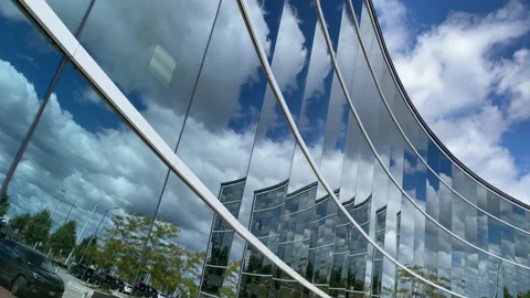 Sunny sky with clouds reflected in modern building glass facade Stock Footage 141822632