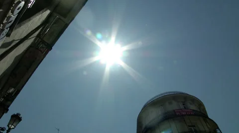 Sunny sky pans down to Madrid intersection Stock Footage 34799583