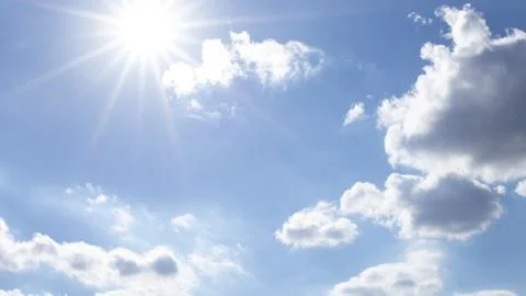 Sunny sky with rays and clouds Stock Photos