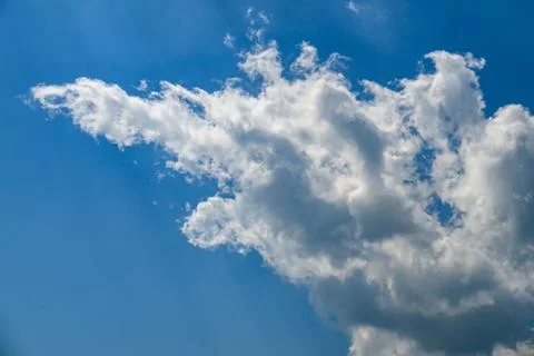 Sunny sky with single dramatic white cloud shape 写真素材