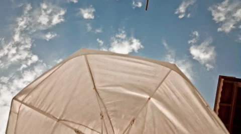 Sunny Sky view Under the Umbrella Time Lapse Stock Footage 32010302
