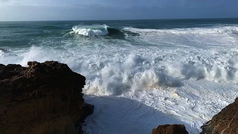 Sunny SloMo Breaking Waves on rocks Stock Footage 107627210