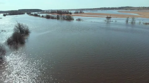 On a sunny spring day, the camera flies fast and low over a flooded field. Stock Footage 153287595