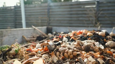 Sunny spring day, compost pile with organics close-up, smooth camera parallax Stock Footage 305690249