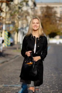 Sunny spring portrait of cheerful blonde model enjoying warm weather, walking Stock Photos