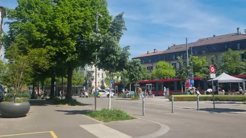 Sunny spring scene at Breitenrain Square in Bern, Switzerland, with pedestrians Stock Footage 342786648