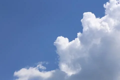 In sunny summer, huge clouds float on the blue sky. Stock Photos