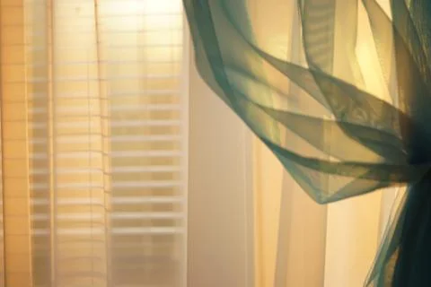 Sunny sunset light through thin curtains on the window 스톡 사진