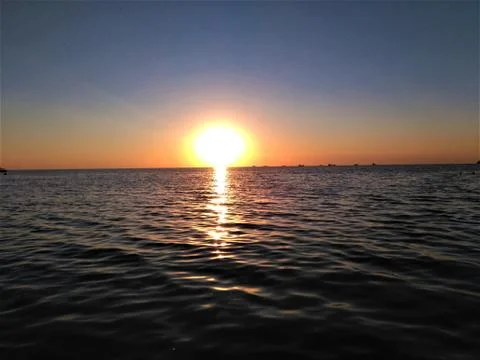 Sunny sunset on the sea Stock Photos