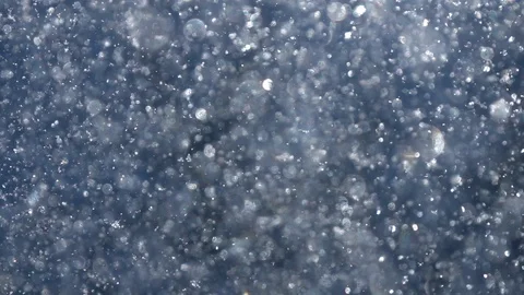Sunny thick snowfall in shallow focus with sparkling snowflakes Stock Footage 87872363