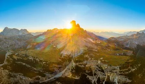 Sunny Three Peaks of Lavaredo under clear sky at sunrise Stock Photos