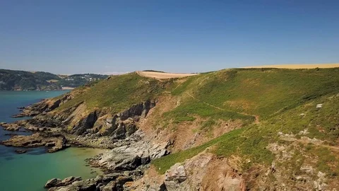 Sunny UK Coast Path, Blue Sea & Rocks - Aerial Drone Footage Stock Footage