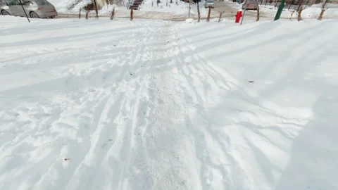Sunny Winter Park With Footprints Marking Snowy Ground Stock Footage 323769076