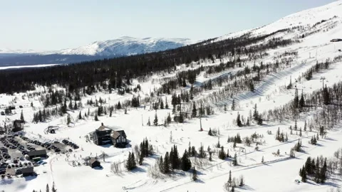 Sunny winter spring skiing day Sweden. Swedish ski slopes above aerial drone Vídeo Stock 153701724