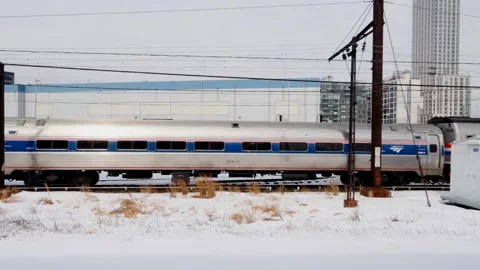 Sunnyside yard the #7 train &amp; Amtrak commuter train passing by. Stock Footage 148456229