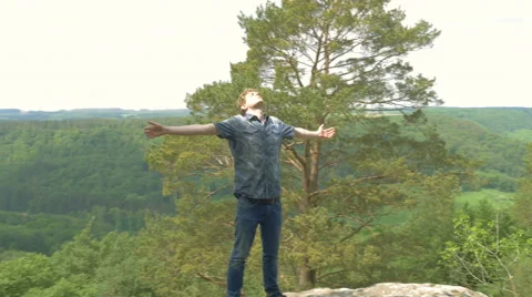 Sunray joy on top of the world man raising arms to the sky praying in 4K Ultr Stock Footage 64024604