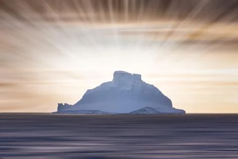 Sunrays behind iceberg Stock Photos